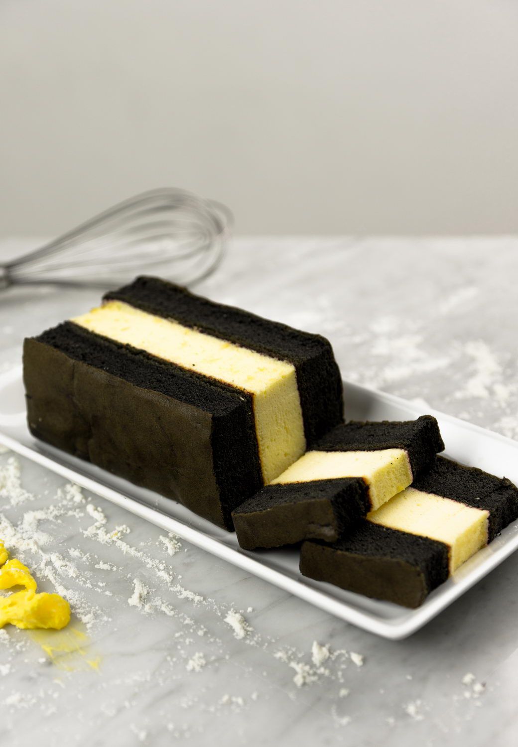 Slices of Spiku Charcoal Cheese with dark charcoal and cheese layers 2